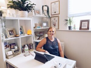 Britt Colston PT | physical therapist for pelvic floor functions sitting at a white desk